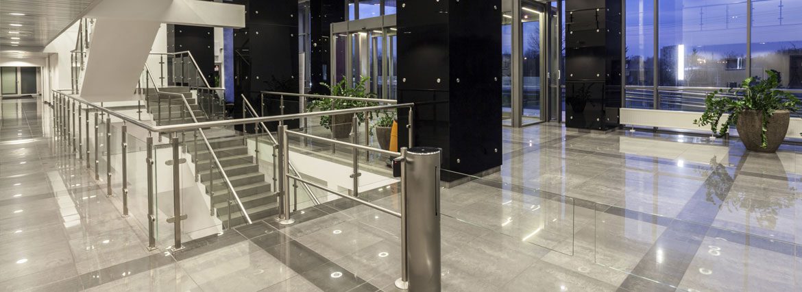 A building with glass walls and stainless steel railings.