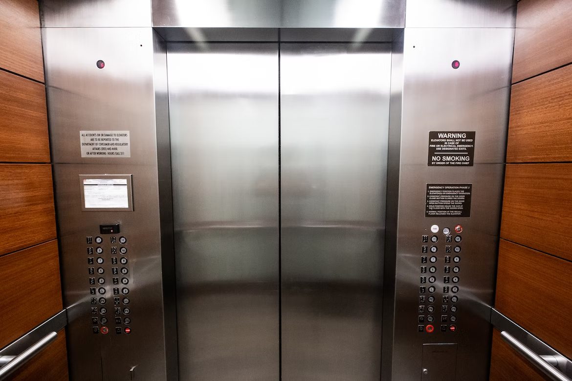 A large metal elevator with two doors.